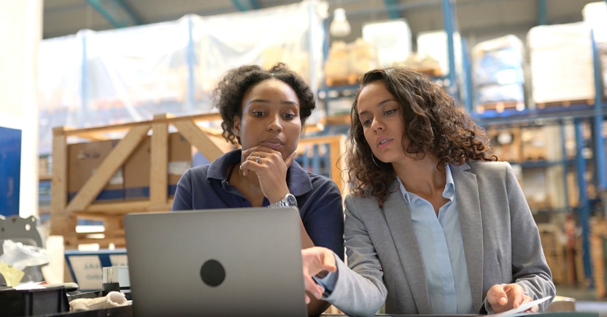 a man and a woman looking at a laptop