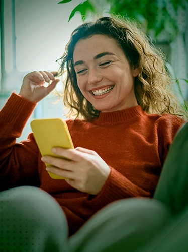 a woman holding a yellow cup