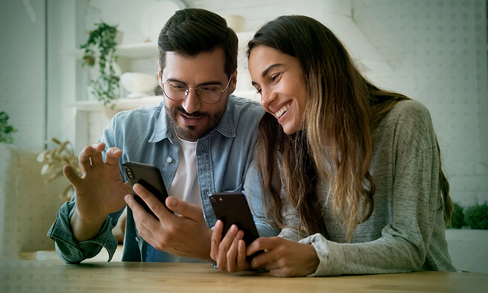 a man and a woman looking at a phone