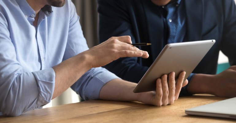 Person helping another person using tablet