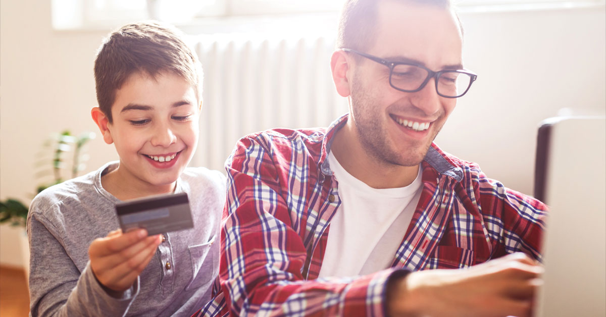 a man and a boy looking at a cell phone