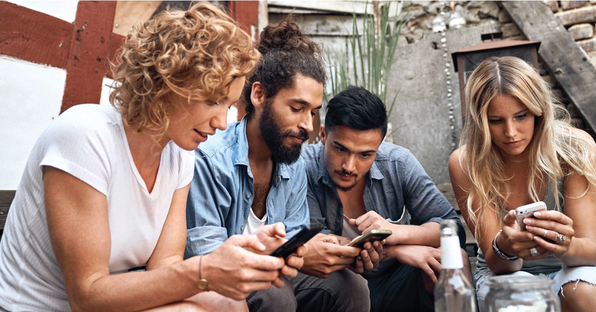 a group of people looking at their phones