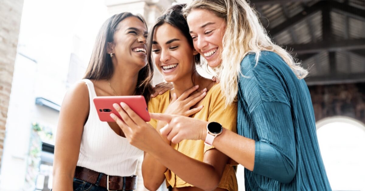 Young ladies staring at phone