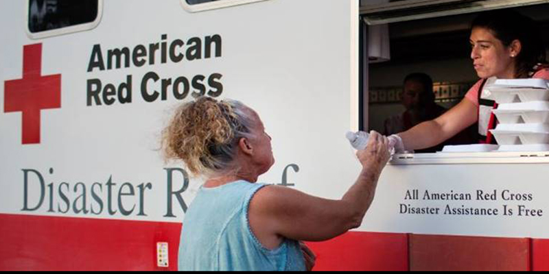 American Red Cross volunteer passes out water