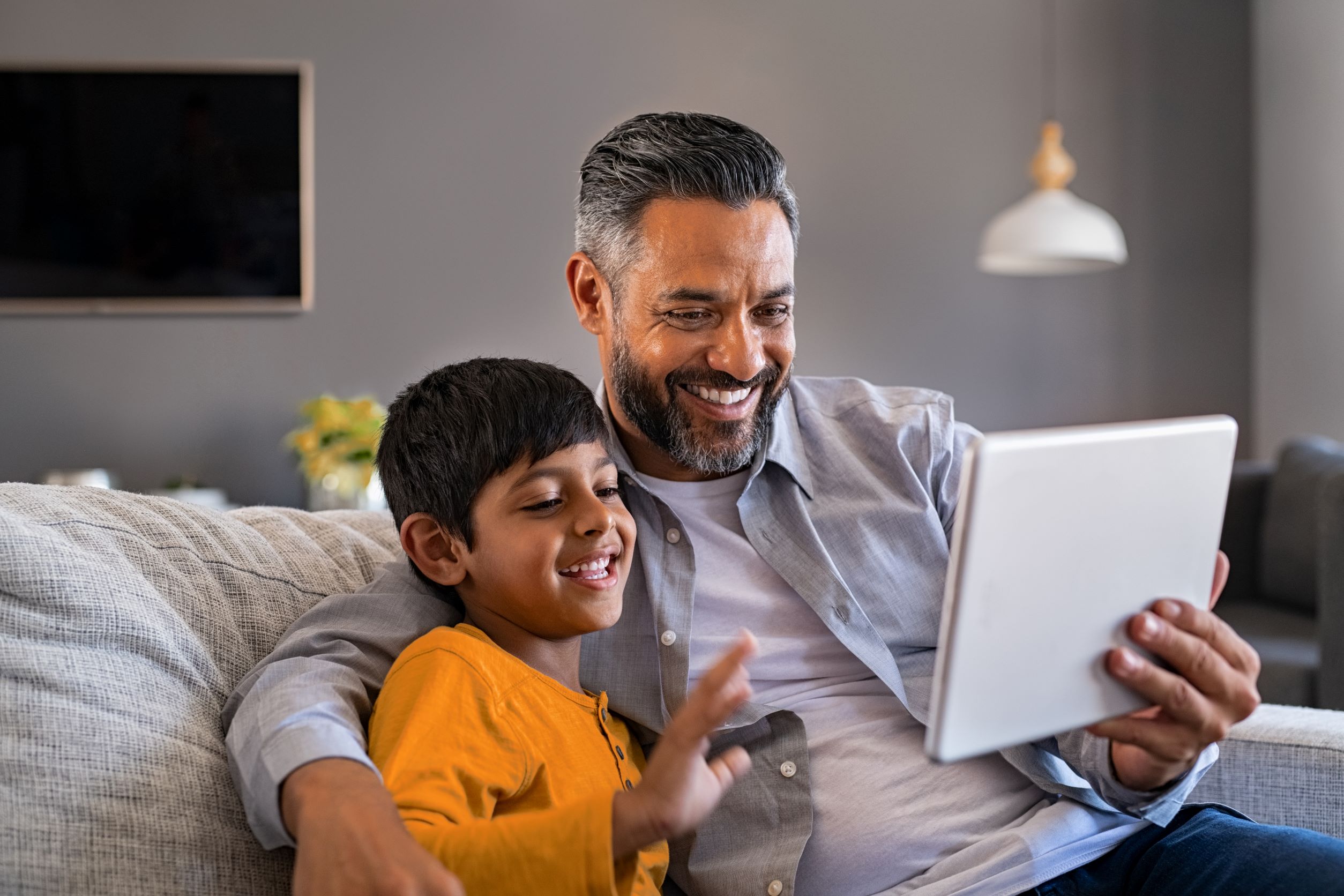 Father and Son Taking Call on Tablet Device