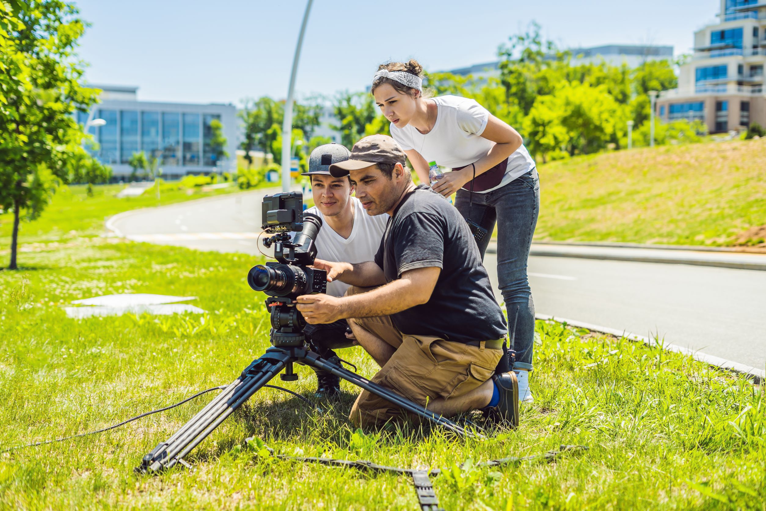 People reviewing camera alongside road