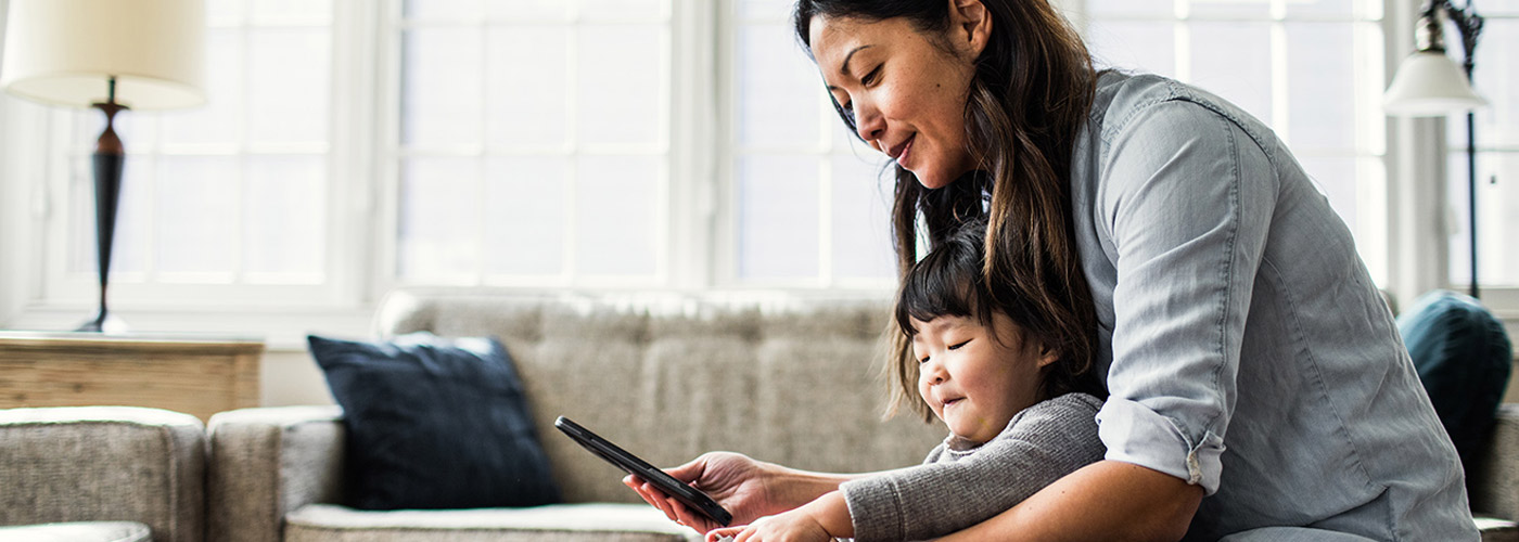 Mom and daughter playing with connected device